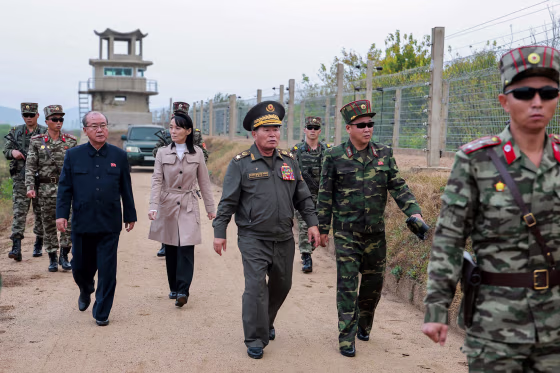 Kim Yo Jong, center left, walking amongst male soldiers.