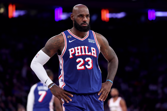 Image: LeBron James during a basketball game, with his hands on his hips.
