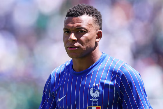 Image: Kylian Mbappe wearing a blue France jersey.