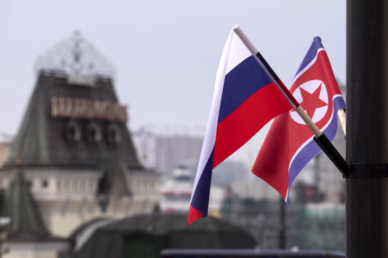 Flags of Russia and North Korea are seen.