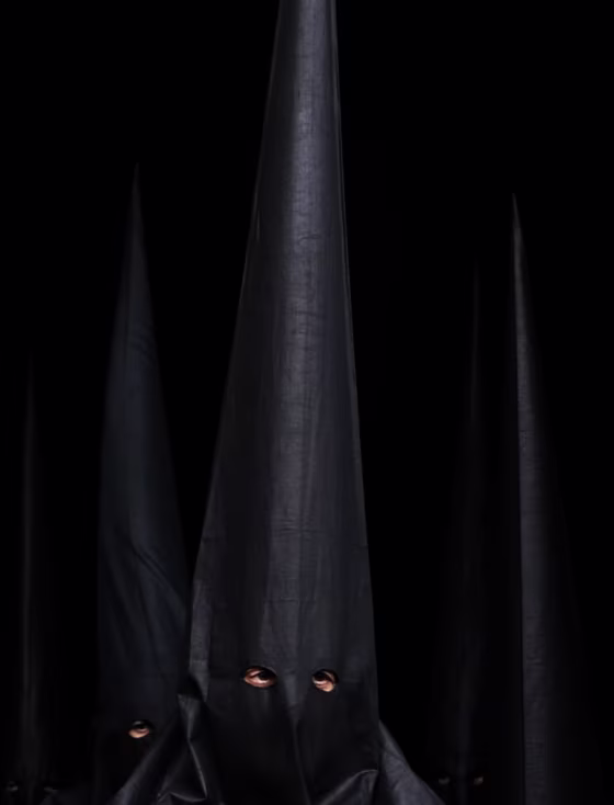 Penitents of 'Los Estudiantes' brotherhood in Seville leave their church on April 3 after their procession was canceled due to bad weather during Holy Week in southern Spain.