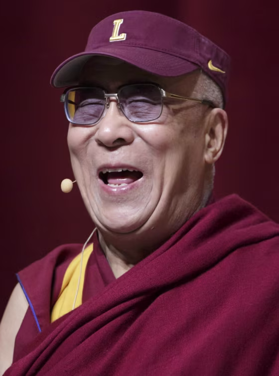 His Holiness the 14th Dalai Lama of Tibet laughs while wearing a Loyola University visor during a speech on non-violence at the university's Lake Shore Campus in Chicago on April 26.  The Dalai Lama, who was in Chicago for the three-day World Summit of Nobel Peace Laureates, received an honorary degree from Loyola.