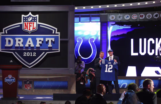 Andrew Luck (R) from Stanford holds up a jersey as he stands on stage with NFL Commissioner Roger Goodell after Luck was selected #1 overall by the Indianapolis Colts in the first round of the 2012 NFL Draft at Radio City Music Hall on Thursday, April 26, 2012 in New York City.