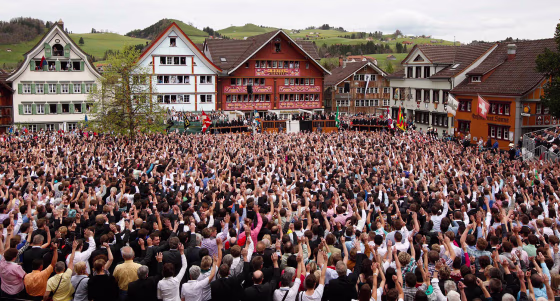 People raise their hands to vote during the annual Landsgemeinde meeting at a square in the town of Appenzell, Switzerland, April 29.