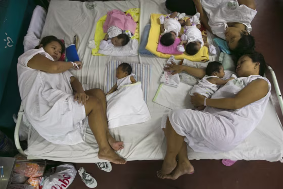 Mothers and their newborns share space on a bed after giving birth in the maternity ward at the government-run Jose Fabella maternity hospital in Manila, Philippines.
