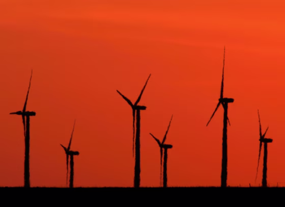 *** HOLD FOR RELEASE 10 a.m. EDT Thursday *** A group of 260-foot-high wind towers are silhouetted against a bright orange sky at the Elk River Wind farm near Beaumont, Kan. May 19, 2006. Wind farms could generate as much as 7 percent of U.S. electricity in 15 years, but scientists want to spend more time studying the threat those spinning blades pose to birds and bats. (AP Photo/Charlie Riedel)