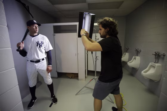 New York Yankees' Alex Rodriguez, left, poses for photographer Nick Laham on photo day during baseball spring training, Monday in Tampa, Fla.