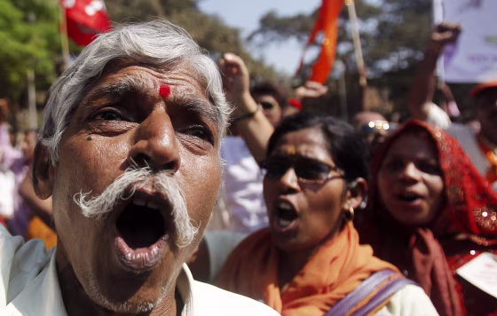Trade union activists shout slogans during a countrywide industrial strike in Mumbai, India, Tuesday, Feb. 28, 2012. Shops and banks were closed, factories shuttered and traffic sparse in major cities across India during an industrial strike Tuesday called by trade unions against the government. Eleven major trade unions called for the strike to protest against rampant inflation. (AP Photo/Rafiq Maqbool)