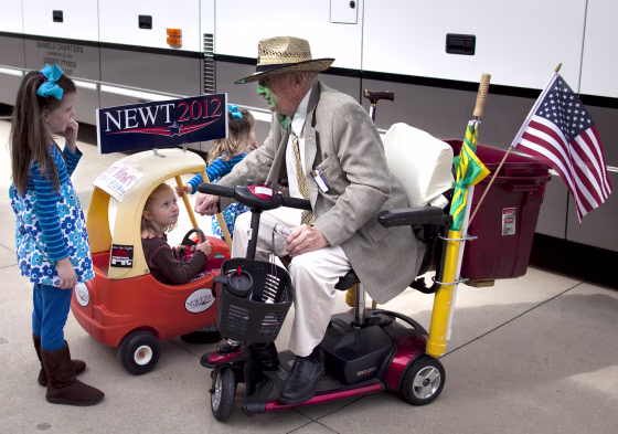 Ray Battle of Cedartown, Ga., right, talks with, from left, Molly Clemmons, 6, of Rome, Ga., Kileigh Barcomb, 5, of Rome, Ga., and Katie Clemmons, 2, of Rome, Ga., before a rally for Republican presidential candidate, former House Speaker Newt Gingrich on Tuesday, Feb. 28, 2012 in Rome, Ga. (AP Photo/Evan Vucci)