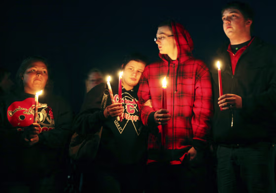 People gather outside St. Mary's of Chardon for a candlelight vigil remembering the victims of a school shooting in Chardon, Ohio February 28, 2012. Three students were killed and two others wounded by suspect TJ Lane in Monday's shooting rampage at the Ohio high school. REUTERS/Shannon Stapleton (UNITED STATES - Tags: CIVIL UNREST CRIME LAW EDUCATION)
