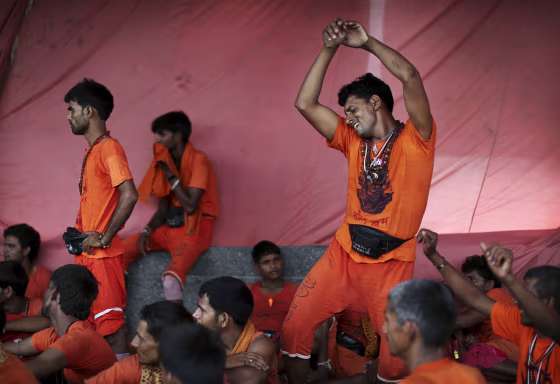 Kanwarias, worshippers of Hindu God Shiva, dance to devotional songs in New Delhi.