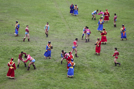 Mongolian wrestlers compete during wrestling competition at the annual Naadam Festival in Ulan Bator, on July 11.