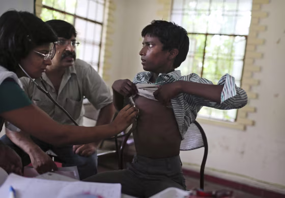 An Indian bonded child laborer is checked by medical workers after being rescued in a raid on July 11, 2012.
