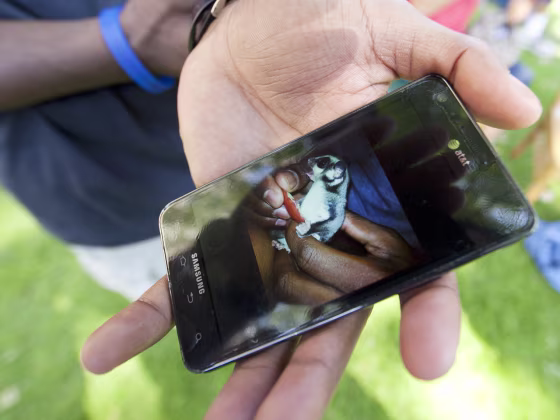 Wrestler Ellis Coleman shows a photo of his beloved flying squirrel, Rocky.
