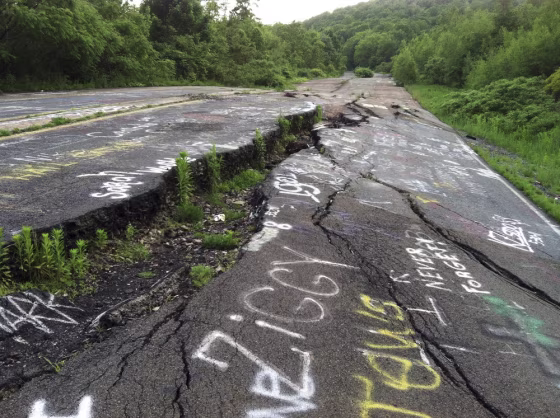 Route 61 is shown eroded and covered in graffiti in Centralia, Pa. Fifty years ago on Sunday, May 27, 2012, a fire at the town dump spread to a network of coal mines underneath hundreds of homes and business in the northeastern Pennsylvania borough of Centralia, eventually forcing the demolition of nearly every building.