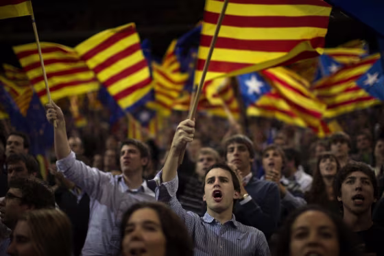 Supporters of center-right Catalan Nationalist Coalition (CiU) leader, Artur Mas, wave their pro-independence