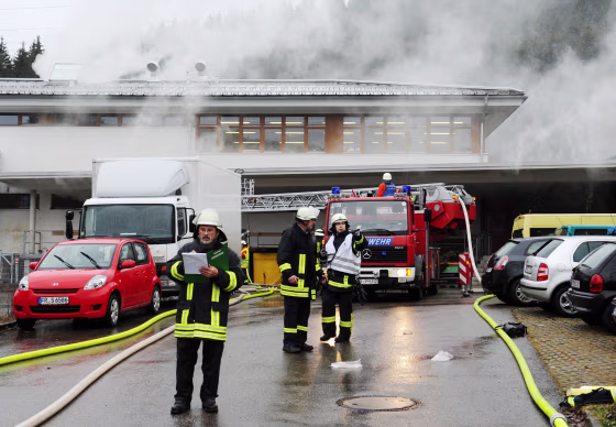 Firemen extinguish a fire at a workshop that employs disabled people in Titisee-Neustadt, Germany on Monday.