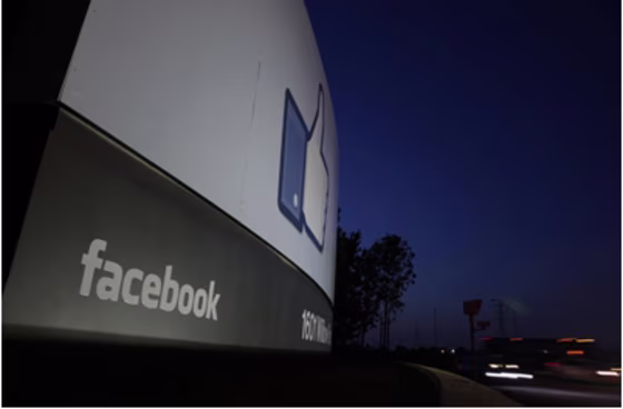 Traffic flies by the entrance sign to Facebook headquarters in Menlo Park, California May 18, 2012.
