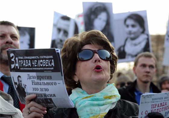 A woman holds a leaflet, reading
