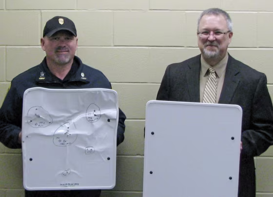 Cold Spring Police Chief Phil Jones, left, and Rocori School District Superintendent Scott Staska hold bulletproof white boards in Cold Spring, Minn., on April 22. Rocori schools are among the first in the nation to acquire the kevlar whiteboards which can be flipped quickly to provide some protection for teachers and students in the event of a shooting.