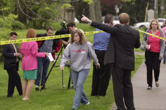 Parents and other family members cross under a police line to check on their children, on April 29, at LaSalle High School in Cincinnati, where a high school student pulled out a gun and shot himself in a classroom on Monday.