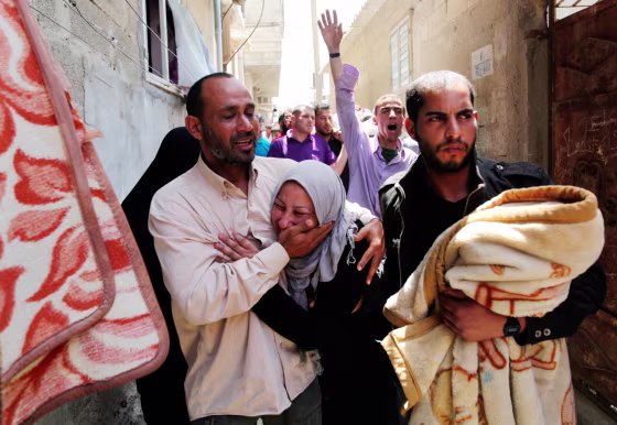 Relatives of a man killed by an Israeli airstrike mourn during his funeral Tuesday in the Shati Refugee Camp in Gaza City. Israel said the man, Hithem Masshal, was a
