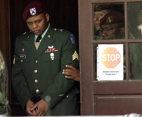 Sgt. Hasan Akbar, left, is led from the Staff Judge Advocate Building at Fort Bragg, N.C., in April 2005, during the sentencing phase of his court-martial.