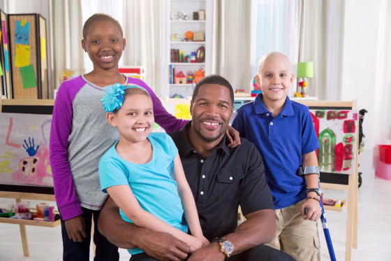 Michael Strahan stars, along with St. Jude patients, in national spots to support the St. Jude Thanks and Giving campaign. (L To R) St. Jude patients Anijah and Laila, Michael Strahan and St. Jude patient Jorge
