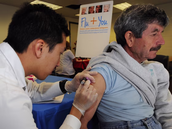 IMAGE DISTRIBUTED FOR NATIONAL COUNCIL ON AGING AND SANOFI PASTEUR - Pharmacist Jason To gives a flu shot to Joao Ferreira during the Flu + You event ...