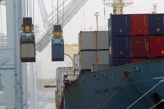 In this Wednesday, Dec. 5, 2012 file photo, containers are unloaded from cargo ships at APM Terminals in the Port of Los Angeles.