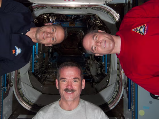 NASA astronaut Tom Marshburn (left), Canadian astronaut Chris Hadfield (center) and space station commander Kevin Ford strike a zero-G pose in the International Space Station's Harmony mode. All three will participate in Friday's Google Hangout.