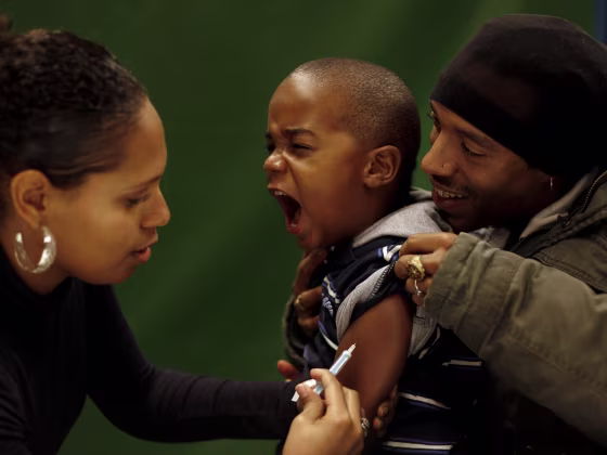 A young child is vaccinated against the H1N1 flu virus in 2009. A new report says the US childhood vaccine schedule is safe.
