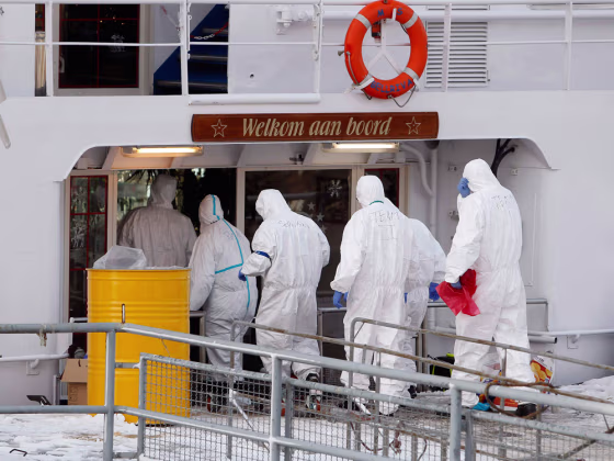 Paramedics dressed in protective attire enter a German cruise ship quarantined in December after an outbreak suspected to be norovirus. A new strain is making people miserable around the world this year.