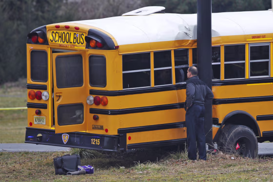 An investigator views the scene of a school bus crash on Feb. 16, 2012, near Chesterfield, N.J.