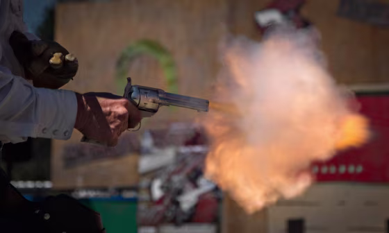 Brian Colwell of Loveland, Colo., fires his single action western style revolver during a competition at the Canadian Open Fast Draw Championships in Aldergrove, British Columbia July 21, 2013.