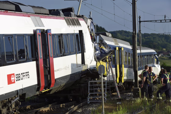 Rescue workers inspects the scene of a train collision in Granges-pres-Marnand in western Switzerland on July 29.