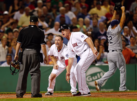 Daniel Nava #29 and Brian Butterfield #13 of the Boston Red Sox plead their case after umpire Jerry Meals called Nava out at the plate against the Tampa Bay Rays in the 8th inning at Fenway Park on July 29, in Boston, Mass.  Nava's run would have tied the game.