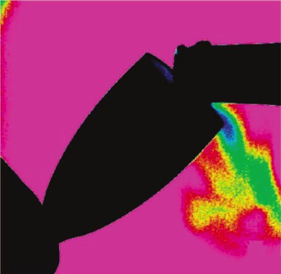 False-color infrared video shows carbon dioxide emanating from a champagne flute while the bubbly is being poured from a bottle stored at 64 degrees Fahrenheit.