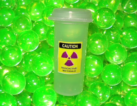 Uranium marbles glow with a greenish hue under ultraviolet light, but they're said to be safe — despite the radioactive sticker on the container.