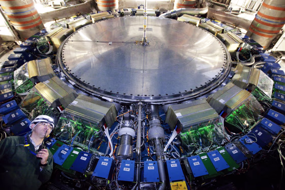A worker stands beneath the ATLAS detector's calorimeter during this month's maintenance break at the Large Hadron Collider.
