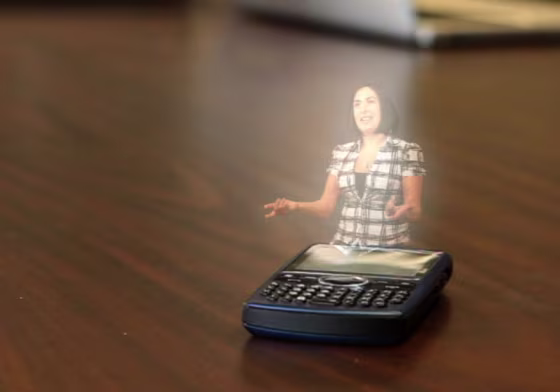 \"Help me, IBM-Kenobi!\" This illustration shows how holographic displays might someday be incorporated into a mobile device. Such a concept is nowhere near reality yet, but IBM's forecasters say it could be in five years.