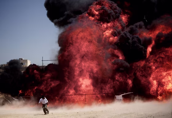 An Iranian man who was fixing explosives wires run away after setting ablaze 50 tons of drugs seized in recent months in eastern Tehran on June 26 to mark the International Day Against Drug Abuse and Illicit Trafficking.
