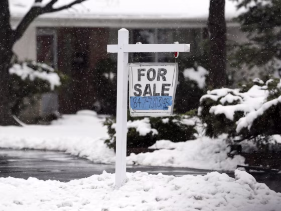 In this Wednesday, Feb. 27, 2013 photo, a for sale sign hangs outside a home in Glenview, Ill. Average U.S. rates on fixed mortgages were little chang...