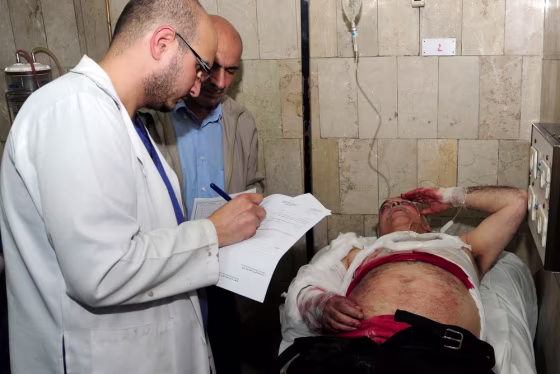 A wounded man receives medical treatment after a mortar attack on Damascus University, at Al Mouwasat hospital in Damascus, Syria, on Thursday. EDITOR'S NOTE: Photo distributed by the state-run Syrian Arab News Agency (SANA).