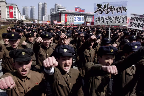 University students punch the air as they march through Kim Il Sung Square in downtown Pyongyang, North Korea, on March 29, 2013.