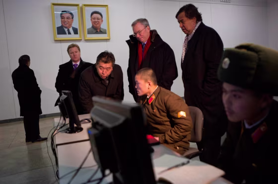 Eric Schmidt, back row left, and former Governor of New Mexico Bill Richardson, back row right, look at North Korean soldiers working on computers at ...