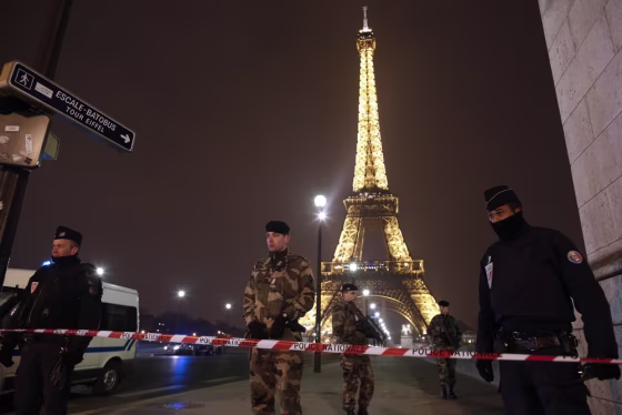 French police stand guard near the Eiffel Tower in Paris on March 30, 2013. The Eiffel Tower was evacuated after an anonymous phone call announced an attack, said a police source. The perimeter of the monument was secured and about 1,400 people were evacuated shortly before 9 p.m.