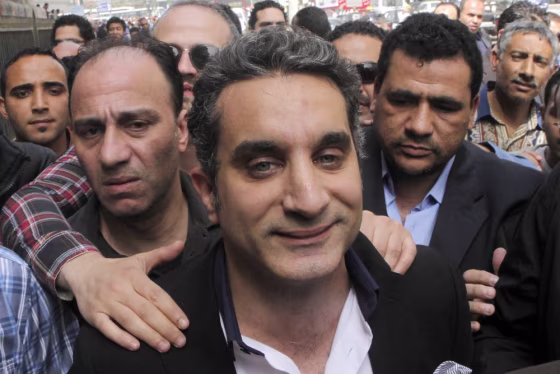 A bodyguard protects popular Egyptian television satirist Bassem Youssef, who has come to be known as Egypt's Jon Stewart.