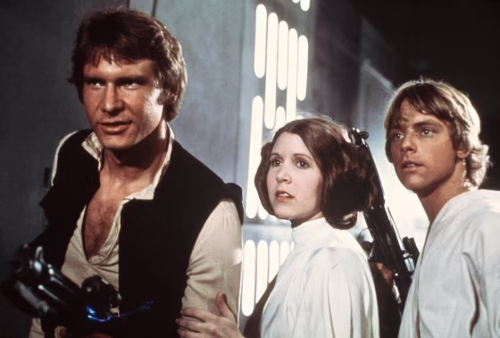 FILE - This file publicity image provided by 20th Century-Fox Film Corporation shows Harrison Ford, as Han Solo, Carrie Fisher, as Princess Leia Organ...