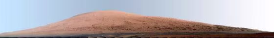 This mosaic of images from the Mast Camera (Mastcam) on NASA's Mars rover Curiosity shows Mount Sharp in a white-balanced color adjustment that makes the sky look overly blue but shows the terrain as if under Earth-like lighting. The component images were taken during the 45th Martian day, or sol, of Curiosity's mission on Mars (Sept. 20, 2012).